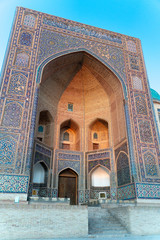 Fototapeta na wymiar The main entrance and gate of Mir Arab madrasasi in Bukhara