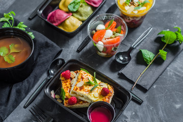 Healthy food and diet concept, restaurant dish delivery. Take away of fitness meal. Weight loss nutrition in boxes. Cottage cheese casserole, salad, soup, ravioli and granola.