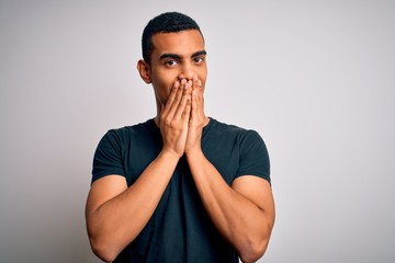 Young handsome african american man wearing casual t-shirt standing over white background laughing...