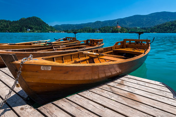 wooden boats on clear blue lake bled
