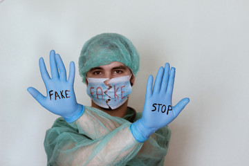 worried doctor with raised hand in whose glove puts the word stop