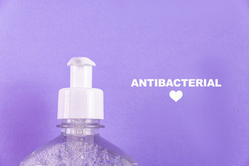 Container with alcohol gel on the light blue background