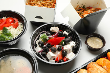Food delivery. Food in take away boxes on white background