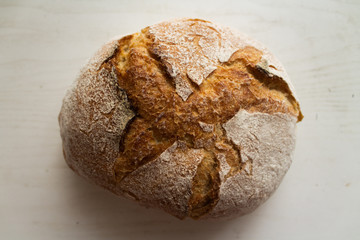 Fresh baked wheat bread on a white background. Top view