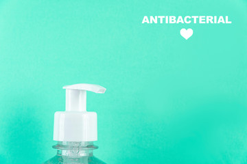 Container with alcohol gel on the light blue background