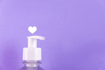 Container with alcohol gel on the light blue background