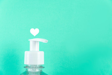 Container with alcohol gel on the light blue background