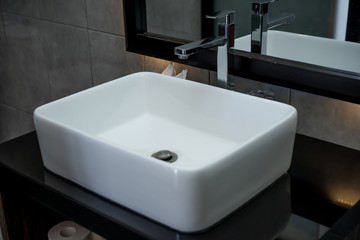 The photo of a sink and mirror in a bathroom