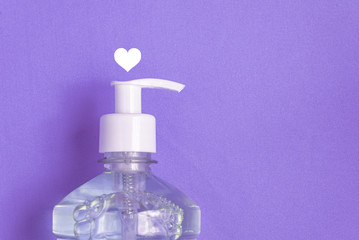 Container with alcohol gel on the light blue background