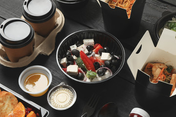 Food delivery. Food in takeaway boxes on wooden table