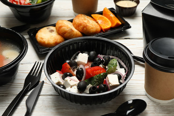 Food delivery. Food in takeaway boxes on wooden table