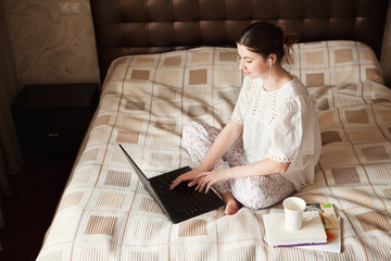 Young woman works, studies at laptop at home. Working from home. Concept home quarantine,...