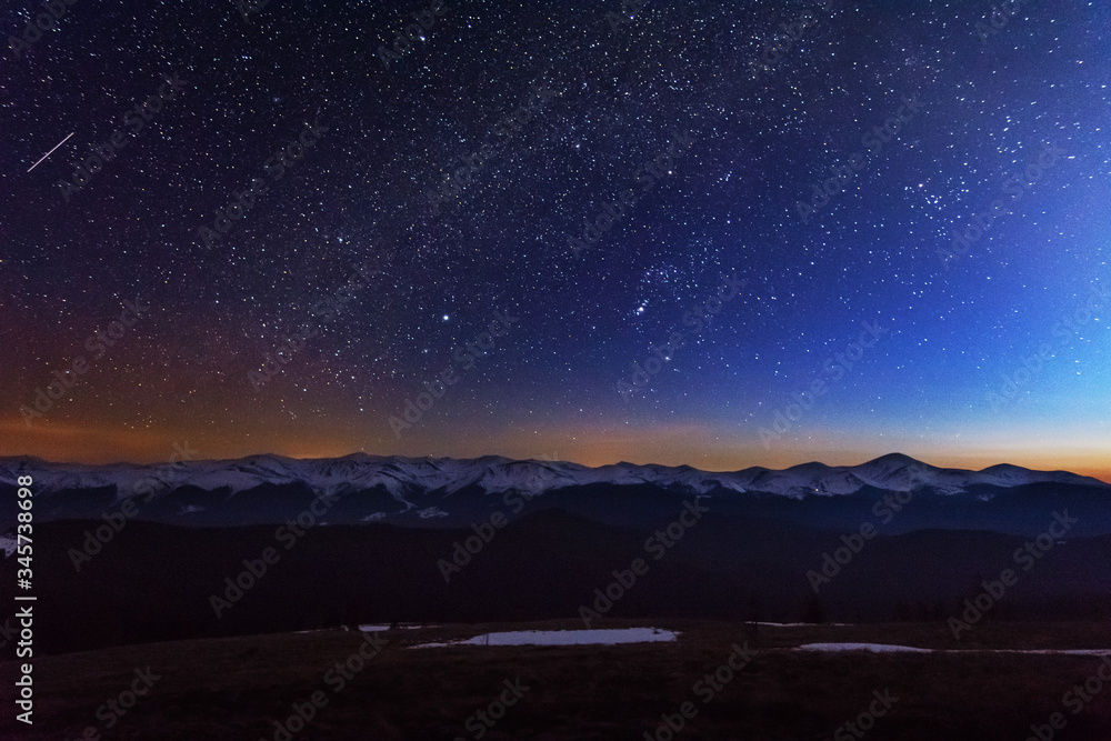 Wall mural fantastic starry night with galaxy milky way with a tourist and a tent on the mountain range in the 