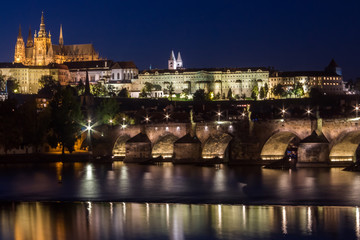 Prague Castle and Charles Bridge in night illumination, panoramic view of Prague.