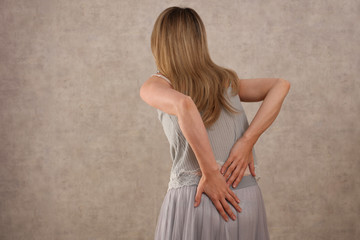 Woman with lower back pain, Scoliosis Pain Relief and Health Care Concept.