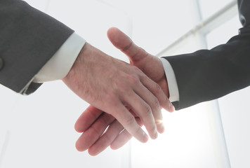 Two business men going to make handshake