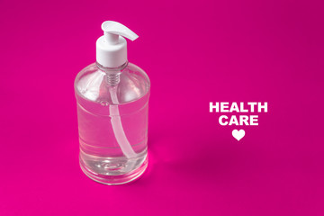 Container with alcohol gel on the red background