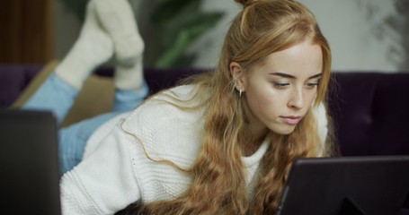 Young woman using digital tablet computer in home