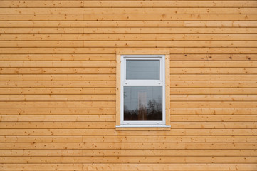 Plastic window on wooden wall