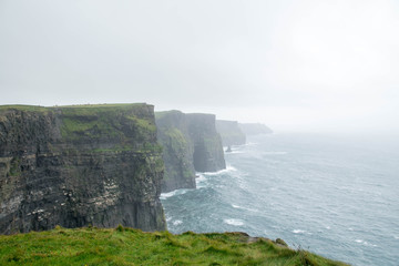 View of Cliffs of Moher on a misty and cloudy day