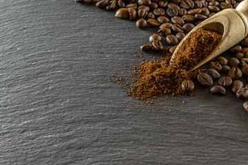 Beans for dark caffeine espresso on black food background. For cup of coffee drink in cafe. Brown roasted coffee seeds isolated for energy mocha, cappuccino ingredient. Macro photography, soft focus