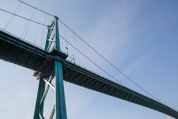 Lions Gate Bridge in Vancouver B.C. suspension bridge with blue sky.