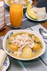 Ajiaco Santafereño, plato tipico colombiano, comida típica del interior de Colombia acompañado de jugo de mango 