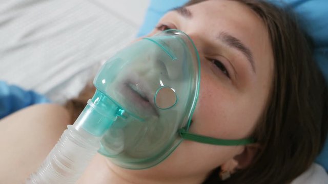 A patient with an oxygen mask in a hospital with a pandemic of the coronavirus Covid19