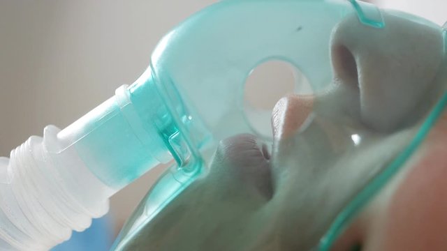 A patient with an oxygen mask in a hospital with a pandemic of the coronavirus Covid19