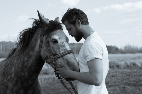 Bearded man with a horse. Sensual photo.
