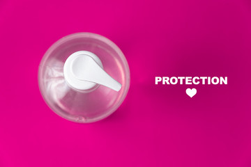 Container with alcohol gel on the red background