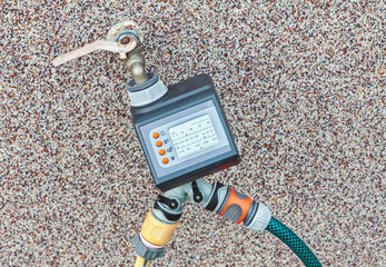 Outdoor water tap with water timer for automating irrigation within a garden, automated watering...