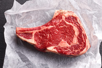 Raw beef steak on paper