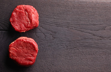 Obraz na płótnie Canvas Raw beef steak on dark background