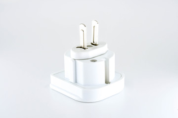 Close up view of a mains power travel adapter plug for the USA isolated against a plain white background.