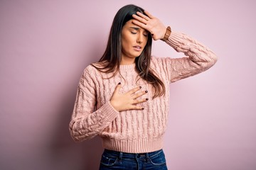 Young beautiful brunette woman wearing casual sweater over isolated pink background Touching forehead for illness and fever, flu and cold, virus sick