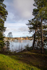 
Sweden. View across the lake to the Gustavsberg promenade under a blue spring sky