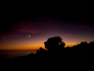 Fototapeta na wymiar Fairytale sunset in the spotlights of lighthouse. Algarve, Portugal.