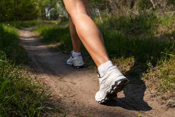 Athletic woman on running track getting ready to start run, back view. athletic legs of a girl