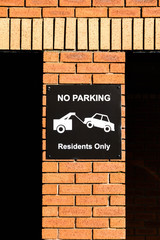 Sign on the wall of an apartment block warning motorists that parking is for residents only