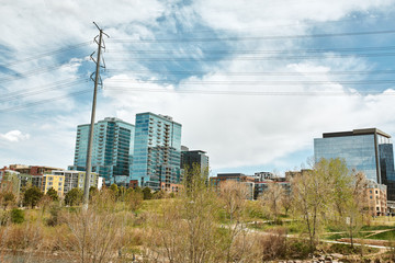 Landscape view of Commons Park with apartments and office buildings in the distance in lower Downtown Denver, Colorado