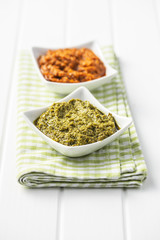 Green basil and red tomato pesto dip sauce