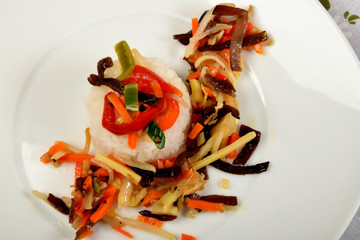 white rice with vegetables on a white plate as a side dish