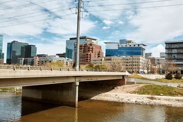 Fototapeta premium South Platte River surrounded by apartments and office buildings at Shoemaker Plaza in Confluence Park. Denver, Colorado