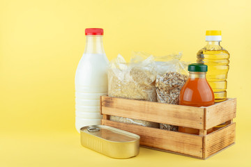 A set of long-term storage products on a yellow background. Food donations or food delivery concept