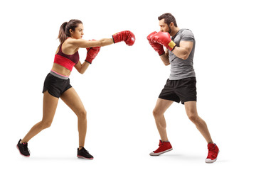 Man and woman in sportswear fighting with boxing gloves