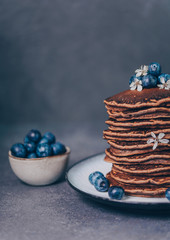 Obraz na płótnie Canvas Sweet delicious chocolate pancakes with blueberries