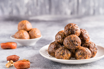 Fruit and nut energy balls in a plate, front view.