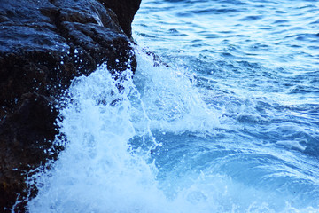 
Mediterranean sea water crashing into rocks