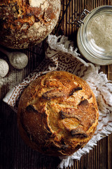 Traditional sourdough bread  on a rustic wooden background, top view.  